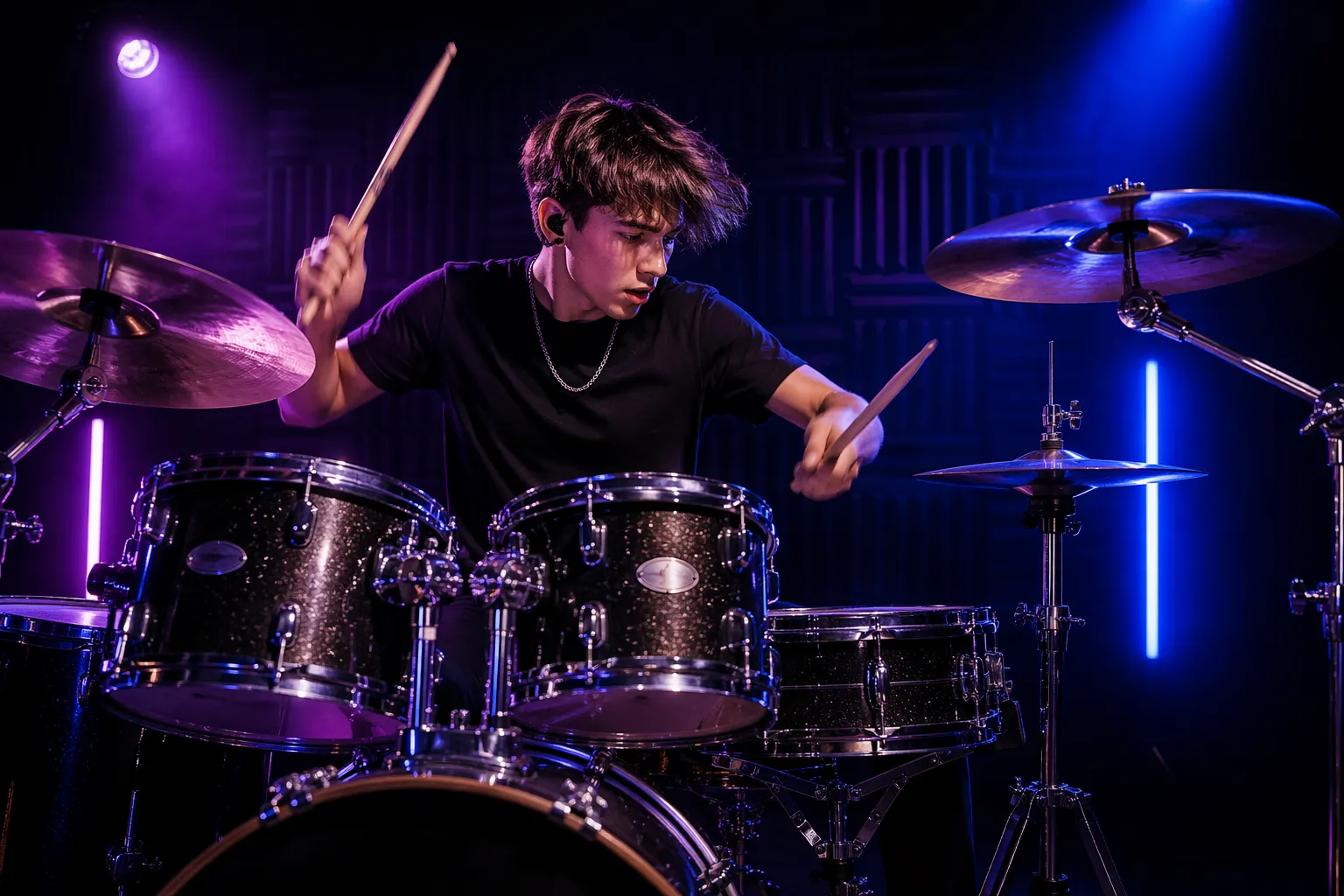 Student playing a full drum kit during a high energy rock drum lesson in a modern studio